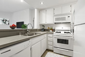 Apartments for Rent Hollywood CA - Kitchen with Stylish Interiors and Convenient Amenities Such As Fridge, Stove, Microwave, and Dishwasher